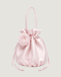 A light pink satin drawstring pouch bag with a matching top handle, featuring a decorative pink fabric flower embellishment on the front.