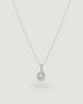A delicate silver chain necklace with a small teardrop-shaped pendant set with a clear gemstone, displayed against a solid light gray background.