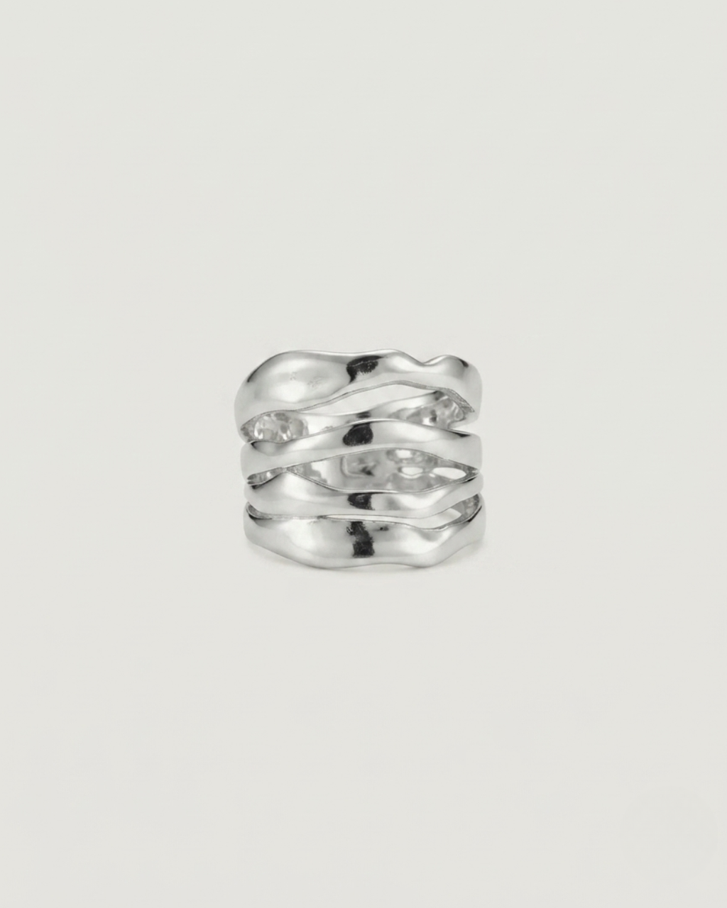 A silver-toned wavy band ring with a textured, organic sculpted design, photographed on a clean, light off-white background.