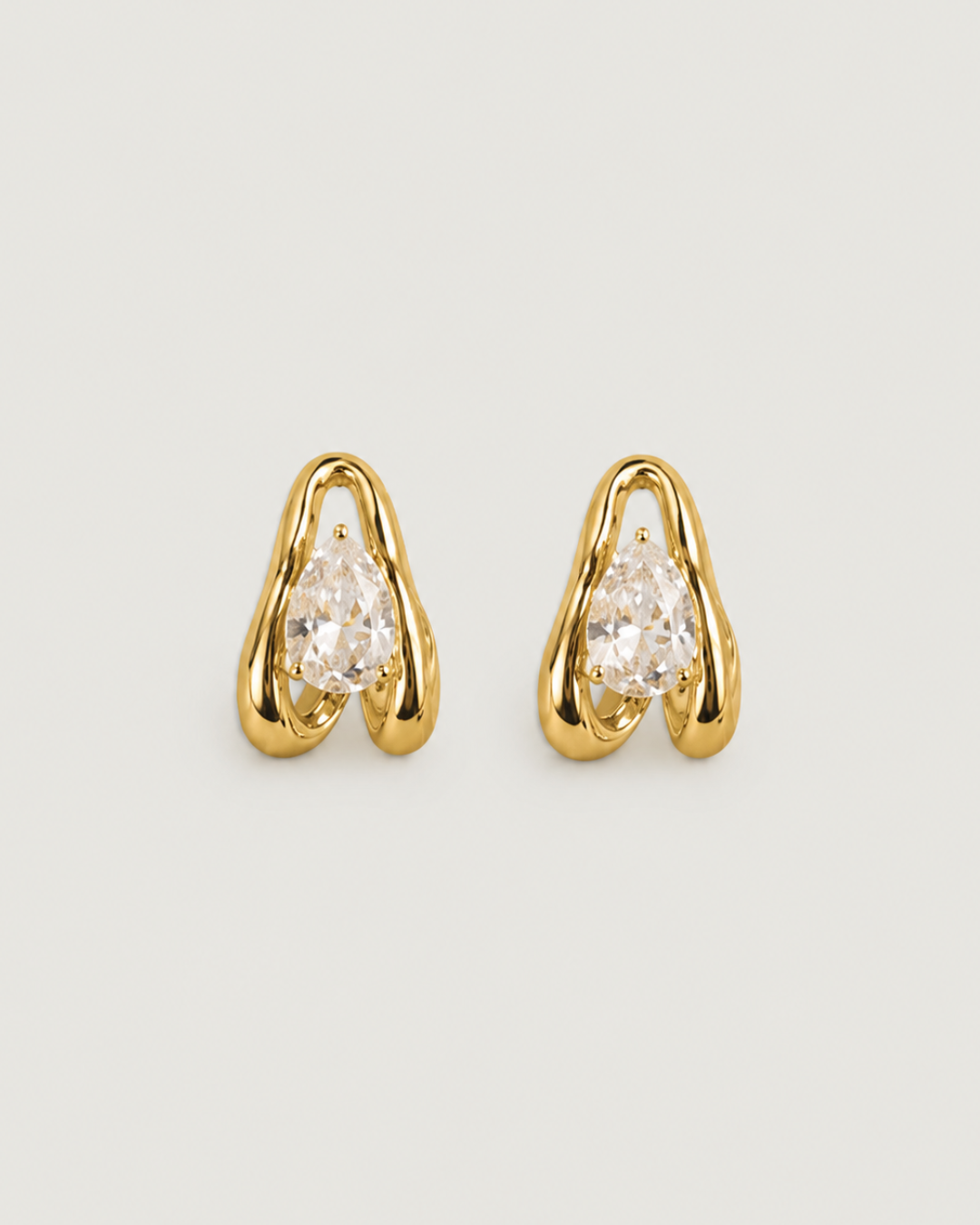 Pair of clear gemstone earrings with gold accents on a white background
