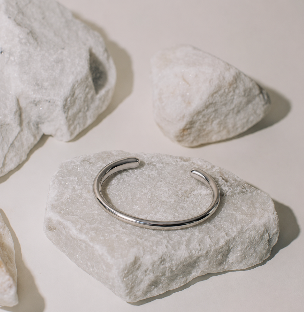 silver metal cuff on stone